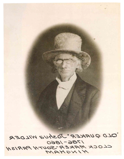 Portrait of an older man wearing glasses and a large top hat.